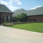 We added a fence with a brick base to create an entry courtyard.